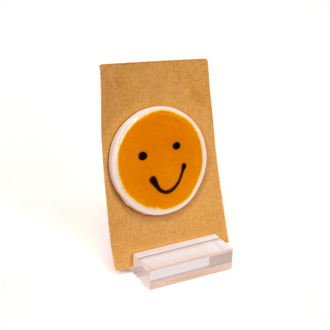 Smiley face ceramic pins