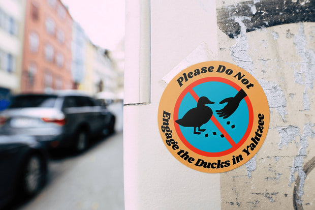 Please Do Not Engage The Ducks In Yahtzee Laptop Sticker: Header tags w/ cellophane baggies